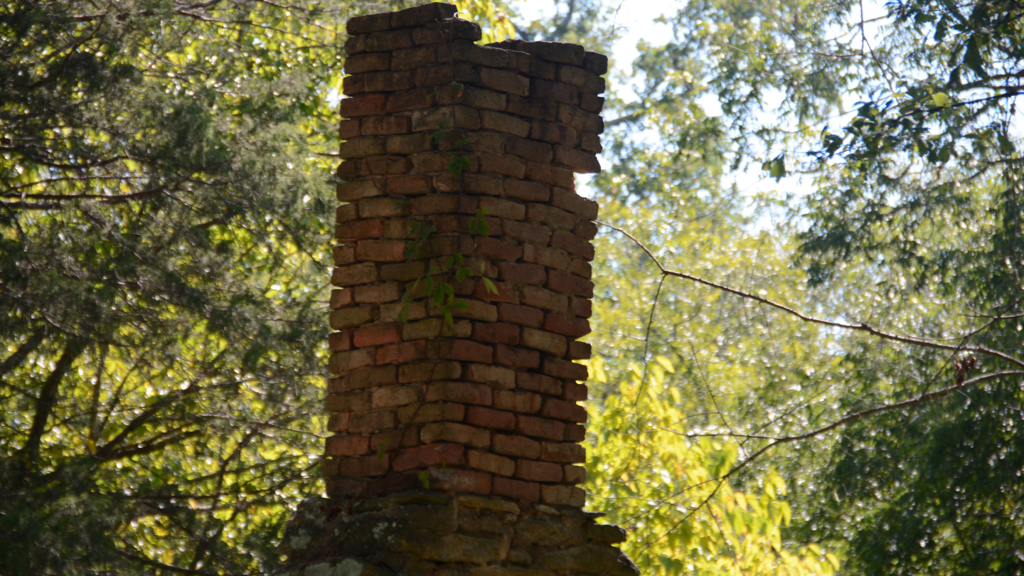 Weathered and damaged chimney stack in Bristol
