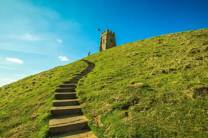Steps climbing the grassy slope of Glastonbury Tor to St Michael's Tower